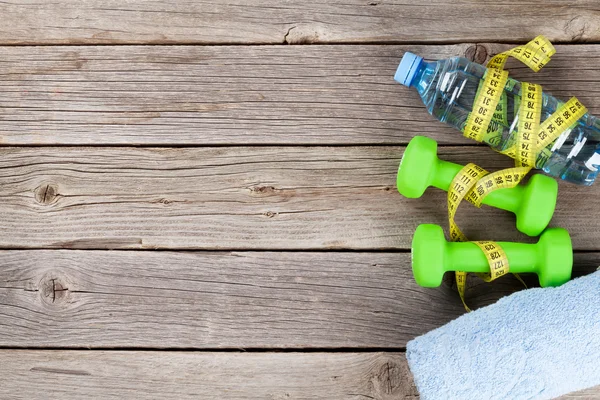 Dumbbells, water and measure tape — Stock Photo, Image