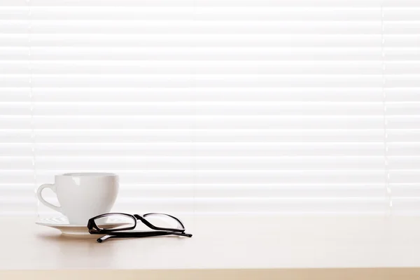 Workplace with coffee cup and glasses — Stock Photo, Image