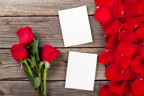 Red roses, photo frames and petals — Stock Photo, Image