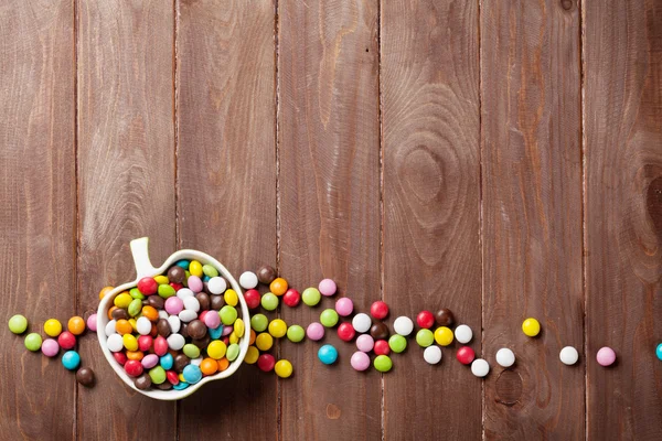 Colorful candies over wood — Stock Photo, Image