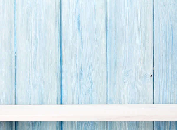 Wood shelf in front of wooden wall — Stock Photo, Image