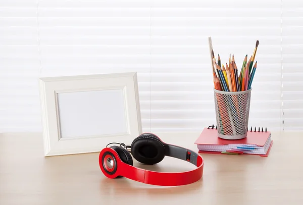 Workplace with photo frame, headphones — Stock Photo, Image
