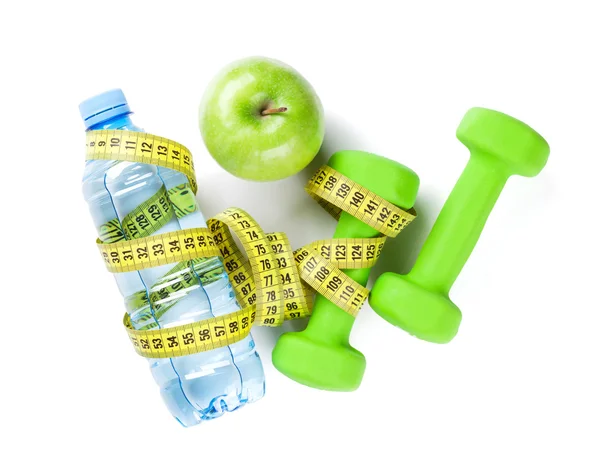 Dumbbells, bottle, apple and tape measure Stock Picture
