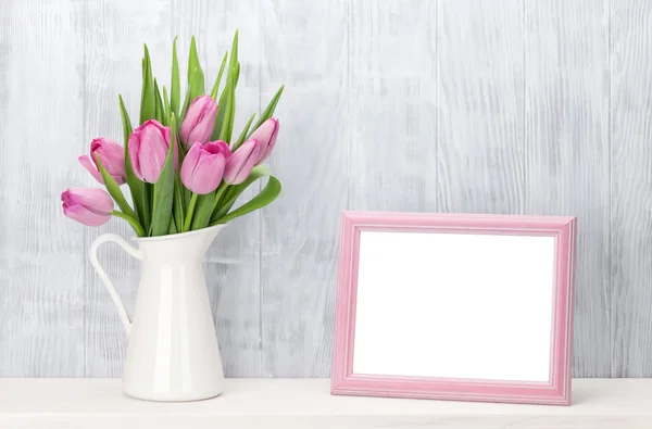 Fresh pink tulips bouquet and photo frame — Stock Photo, Image