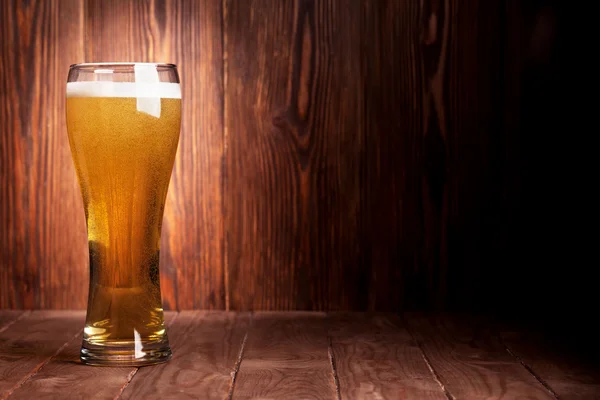 Lager beer glass on wooden table — Stock Photo, Image