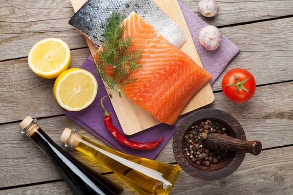 Salmon, spices and condiments — Stock Photo, Image