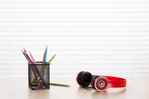 Office workplace with headphones and pencils — Stock Photo, Image