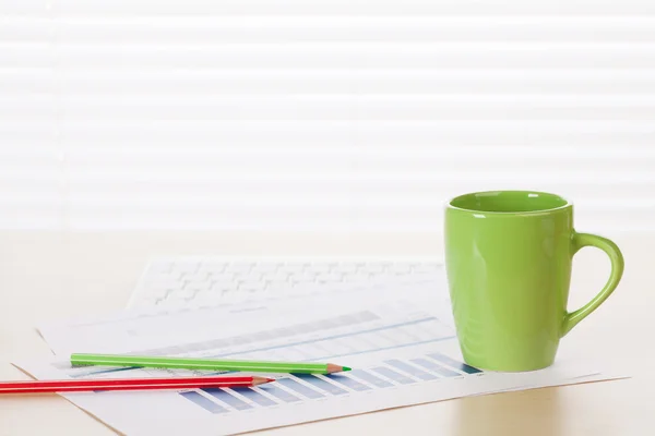 Office arbetsplatsen med kaffe, leveranser och rapporter — Stockfoto