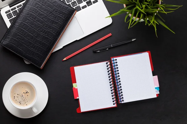 Office desk with laptop, coffee, notepad — Stock Photo, Image