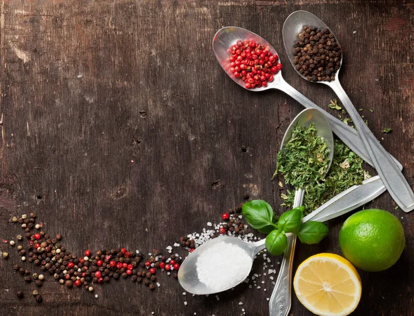 Herbs and spices on wooden table — Stock Photo, Image