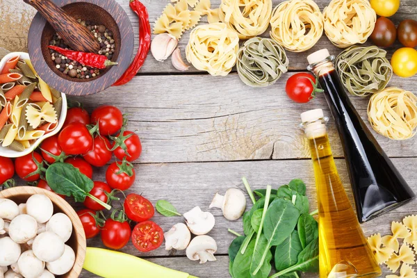 Fresh ingredients for cooking: pasta, tomato and spices — Stock Photo, Image