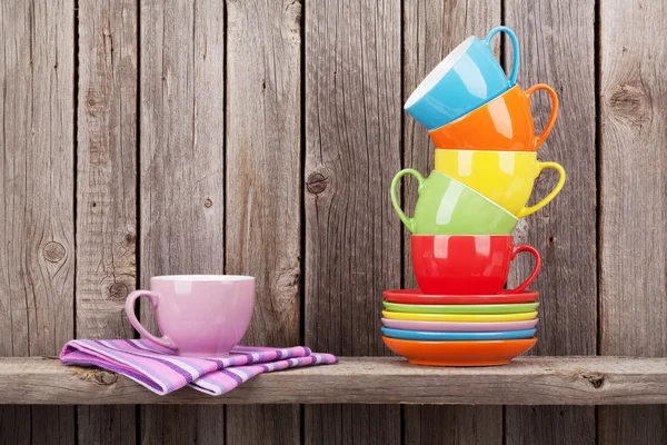 Colorful coffee cups on shelf — Stock Photo, Image