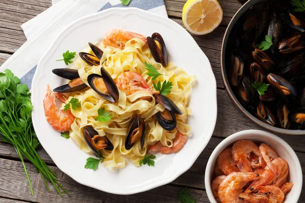 Pasta with seafood on wooden table — Stock Photo, Image