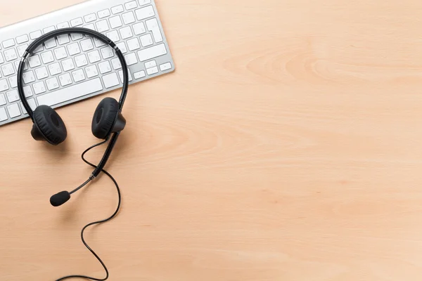 Office desk with headset. — Stock Photo, Image