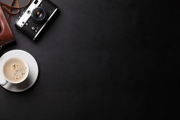 Office desk with camera and coffee — Stock Photo, Image