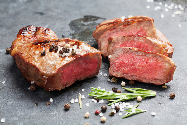 Grilled striploin sliced steak on stone table
