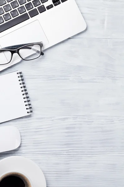 Desk table with laptop, coffee, notepad and glasses — Stock Photo, Image