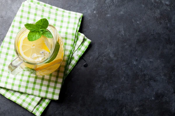 Lemonade pitcher with lemon, mint and ice — Stock Photo, Image