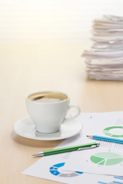 Office workplace with coffee, supplies and reports — Stock Photo, Image