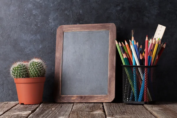 Supplies, cactus and chalk board — Stock Photo, Image