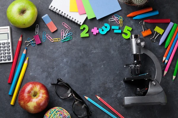 Supplies over chalk board — Stock Photo, Image