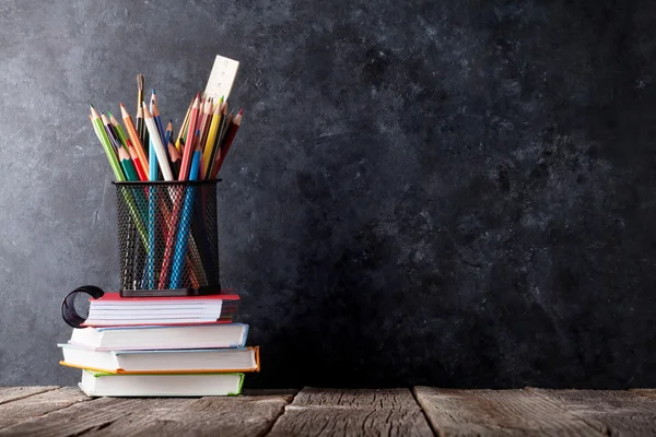 Supplies in front of chalk board — Stock Photo, Image