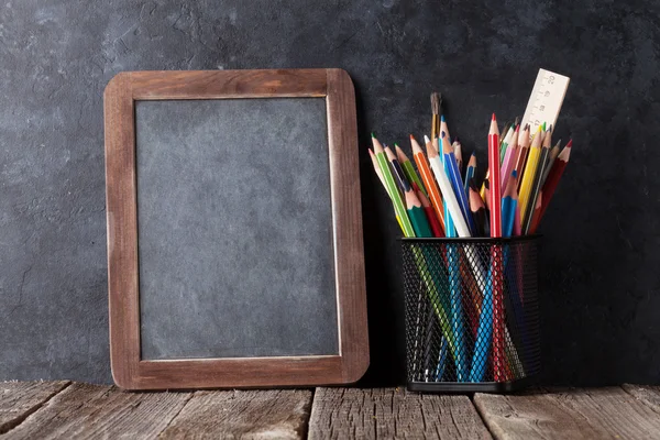 Supplies and chalk board — Stock Photo, Image