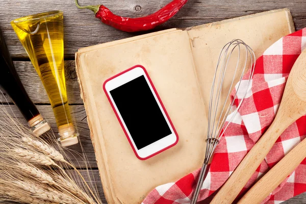 Keukentafel met keukengerei en telefoon — Stockfoto