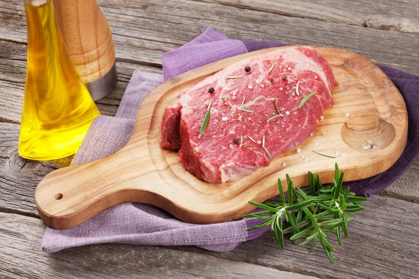 Raw beef steak with spices and herbs — Stock Photo, Image