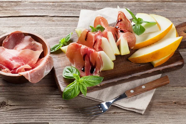 Melon with prosciutto and mint — Stock Photo, Image