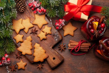 İçinde sıcak şarap, zencefilli kurabiye, hediye kutusu ve xmas ağacı olan Noel tebrik kartı. Üst görünüm düzlüğü