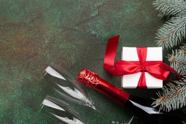 Noel tebrik kartı, köknar ağacı, şampanya ve taştan arka planda hediye kutusu. Üst görünüm düzlüğü Xmas selamlamalarınız için boşluk ile yatar