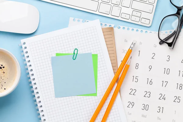 Business desk workplace and office objects over blue backdrop. Top view flat lay with copy space for your text