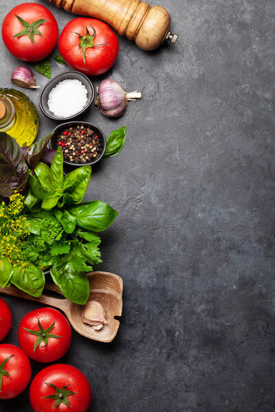 Italian cuisine ingredients. Garden tomatoes, herbs and spices. Top view with copy space. Flat lay