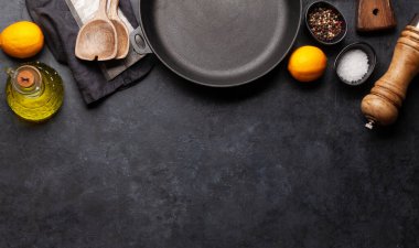 Mutfak masasında tava, kap kacak ve malzemeler var. Üst görünüm düzlüğü kopyalama alanı ile yatıyordu