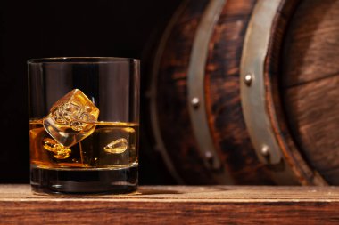 Scotch whiskey glass and old wooden barrel clipart