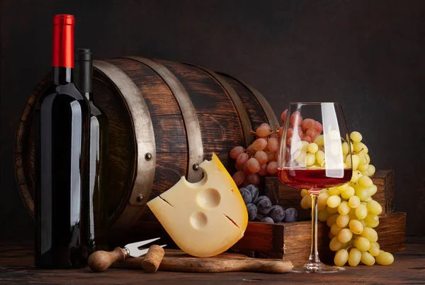 Weinflaschen Trauben Käse Ein Glas Rotwein Und Ein Altes Holzfass — Stockfoto