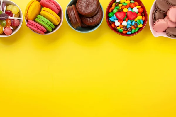 Various Sweets Assortment Candy Bonbon Macaroons Yellow Background Top View — Stock Photo, Image