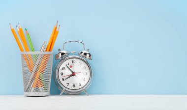 Alarm saati ve ofis malzemeleriyle stüdyo çalışma alanı. Kopyalama alanı ile