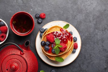 Kahvaltı için çay ve yaz meyveli nefis ev yapımı krepler. Kopyalama alanı olan üst görünüm