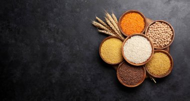 Glütensiz mısır gevreği. Pirinç, karabuğday, mısır, kinoa ve darı ahşap kaselerde. Üst görünüm düzlüğü kopyalama alanı ile yatıyordu