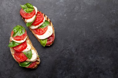 Caprese salatası, mozzarella, fesleğen, ızgarada taze domates. Üst görünüm düzlüğü kopyalama alanı ile yatıyordu