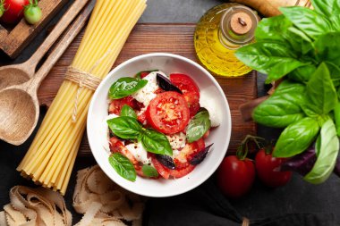 Taze domatesli Caprese salatası, fesleğen ve mozzarella peyniri. Üst görünüm düzlüğü