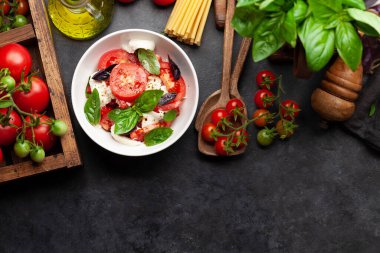 Taze domatesli Caprese salatası, fesleğen ve mozzarella peyniri. Üst görünüm düzlüğü kopyalama alanı ile yatıyordu