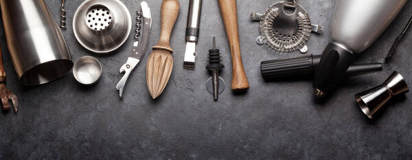 Cocktail and drinks utensils. Set of bar tools on stone table. Top view flat lay