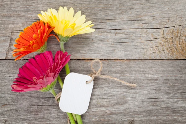 Gerbera flowers with tag — Stock Photo, Image