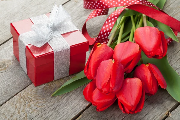 Fresh red tulips with gift box — Stock Photo, Image