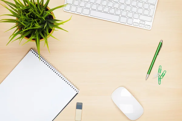 Office table with notepad and flower