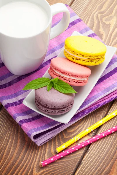 Macaron cookies and cup of milk — Stock Photo, Image