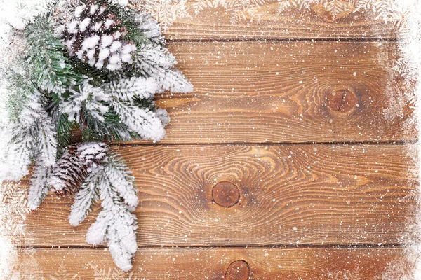 Wood texture with snow and firtree — Stock Photo, Image